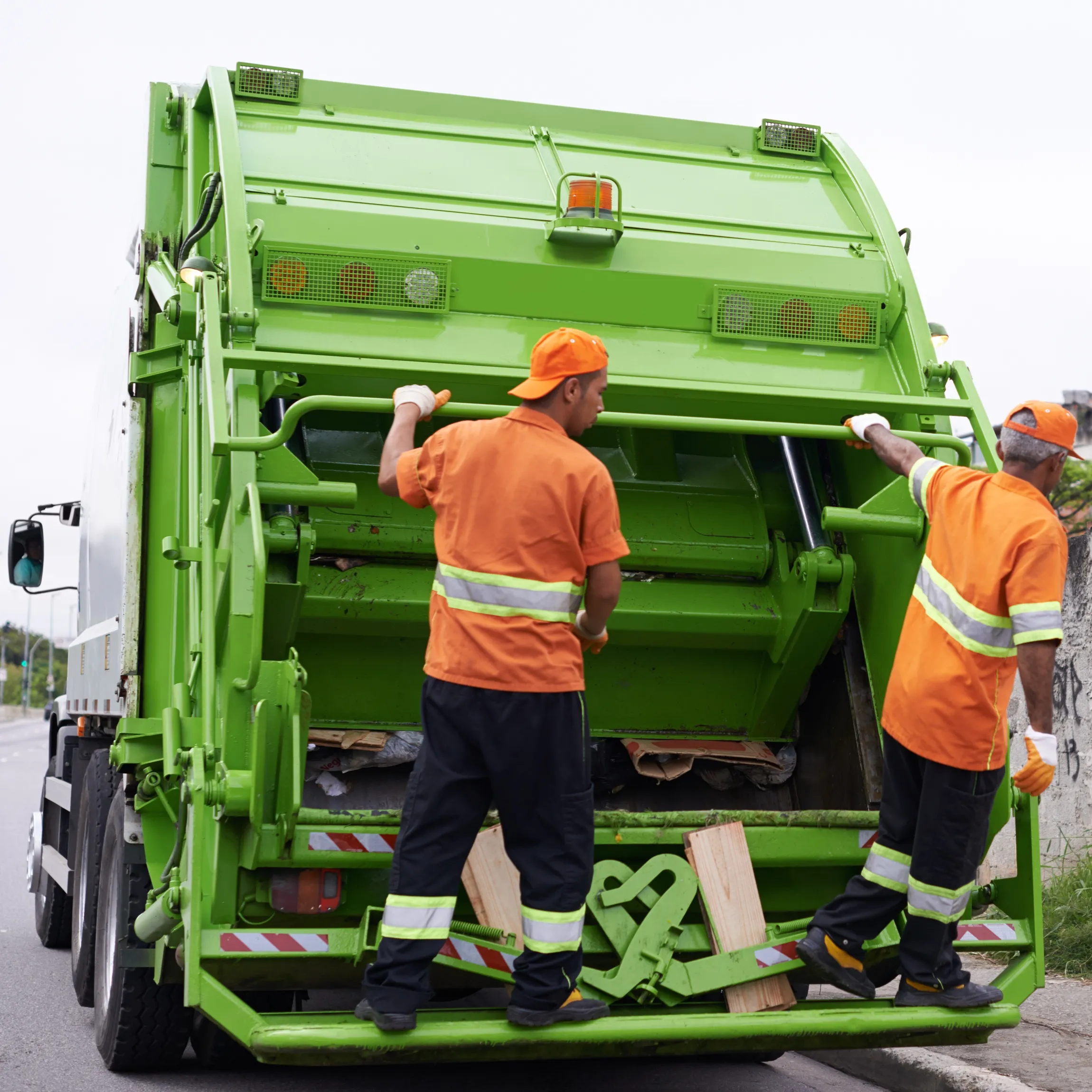 Team of foreign workers performing waste collection and management services, ensuring compliance with international recruitment and occupational safety standards.