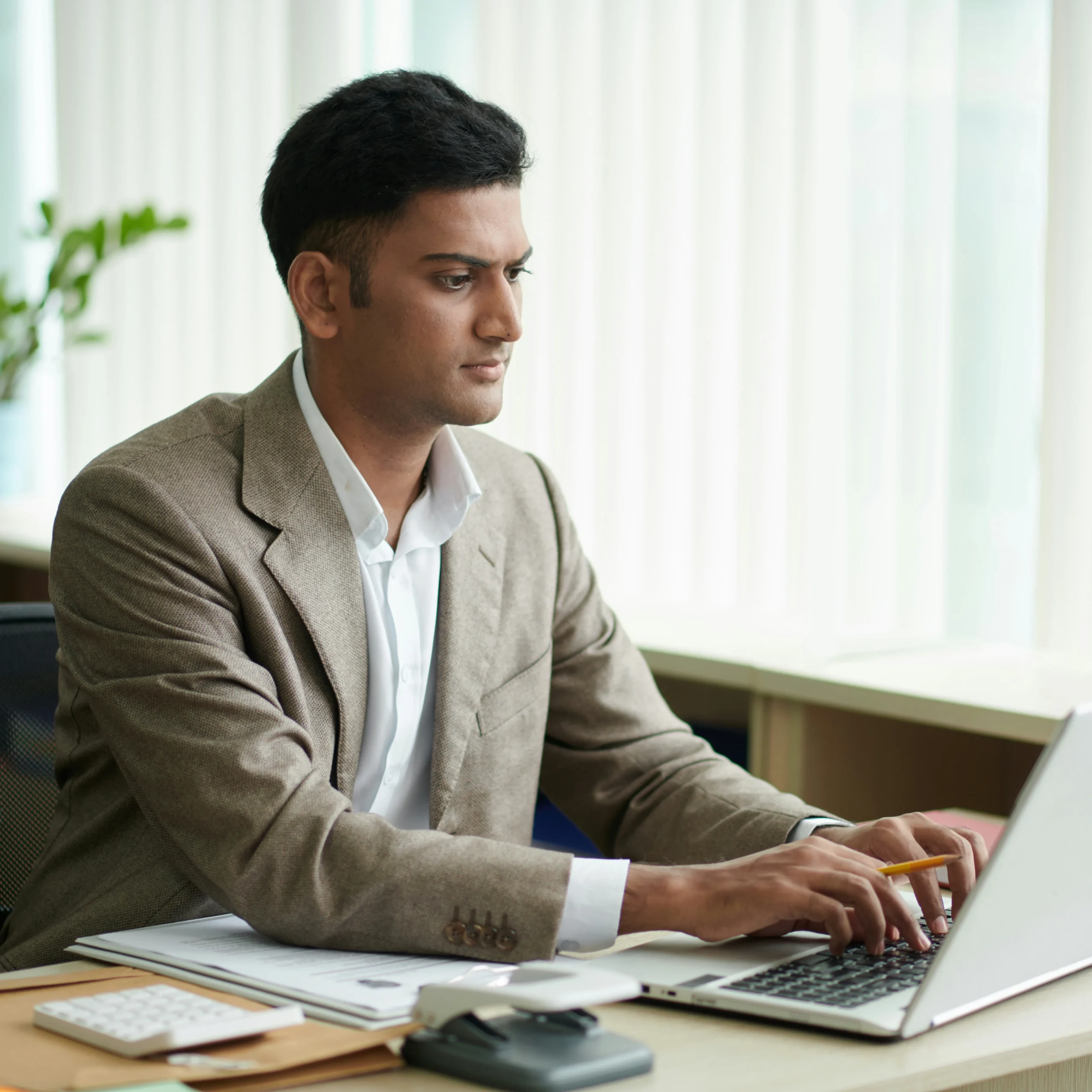 Skilled foreign banking professional performing financial operations at a workstation, aligned with international labor, compliance, and banking standards.